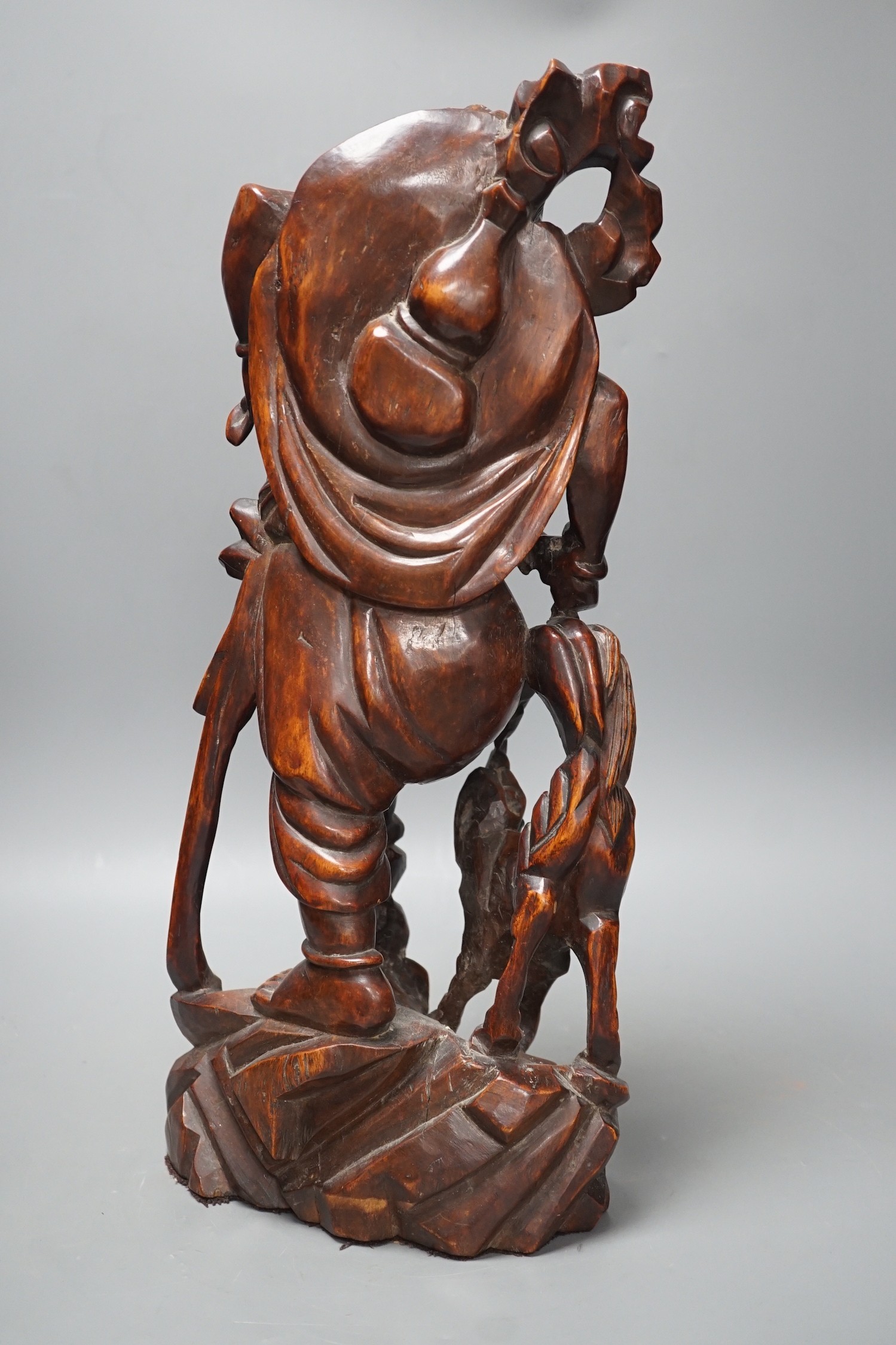 A large Chinese hardwood figure of Liu Hai, early 20th century, 47cm